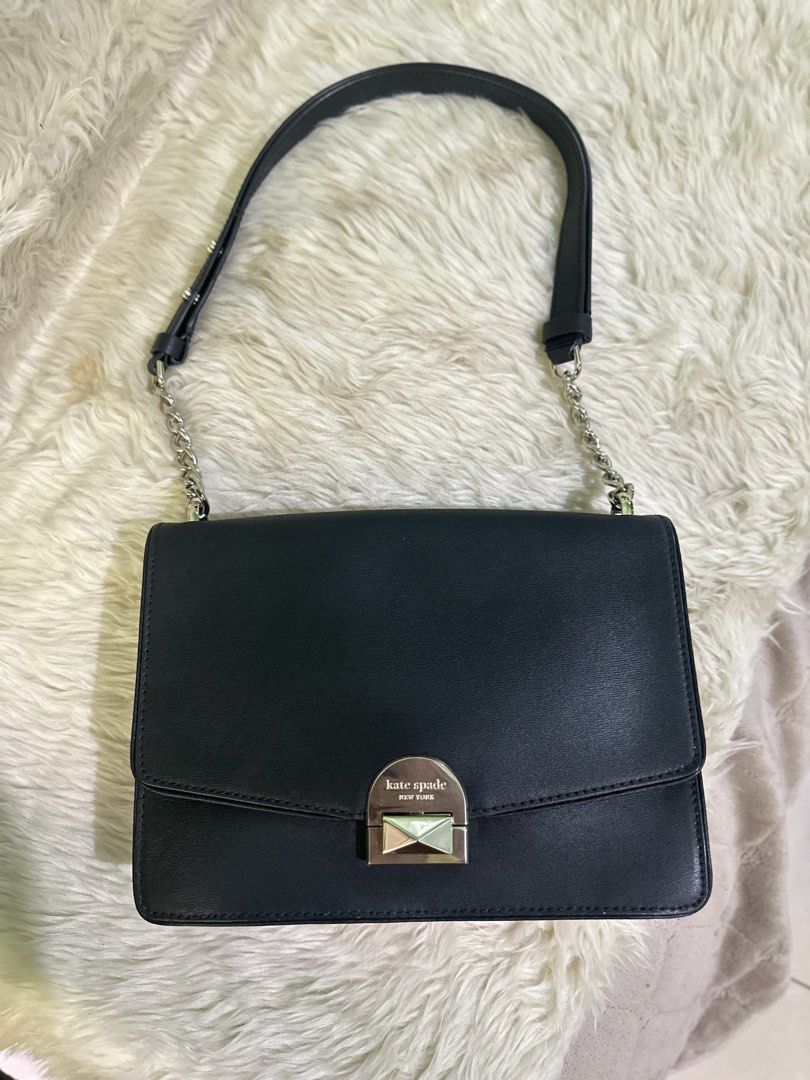 Kate Spade Black Leather Shoulder Bag (Category: Luxury Bags & Wallets) located in Angeles City. Submitted by chicprelovedstuffs.owl (Listing ID 1433410887, Image 2). Description: - Kate Spade shoulder bag - Black leather exterior - Chain strap - Flap closure with silver-tone metal detail - Light pink interior lining - Includes tags and care card - Perfect for everyday or special occasions Looks brandnew; Used once RFS: Decluttering.