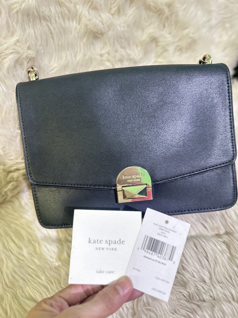 Kate Spade Black Leather Shoulder Bag (Category: Luxury Bags & Wallets) located in Angeles City. Submitted by chicprelovedstuffs.owl (Listing ID 1433410887, Image 3). Description: - Kate Spade shoulder bag - Black leather exterior - Chain strap - Flap closure with silver-tone metal detail - Light pink interior lining - Includes tags and care card - Perfect for everyday or special occasions Looks brandnew; Used once RFS: Decluttering.
