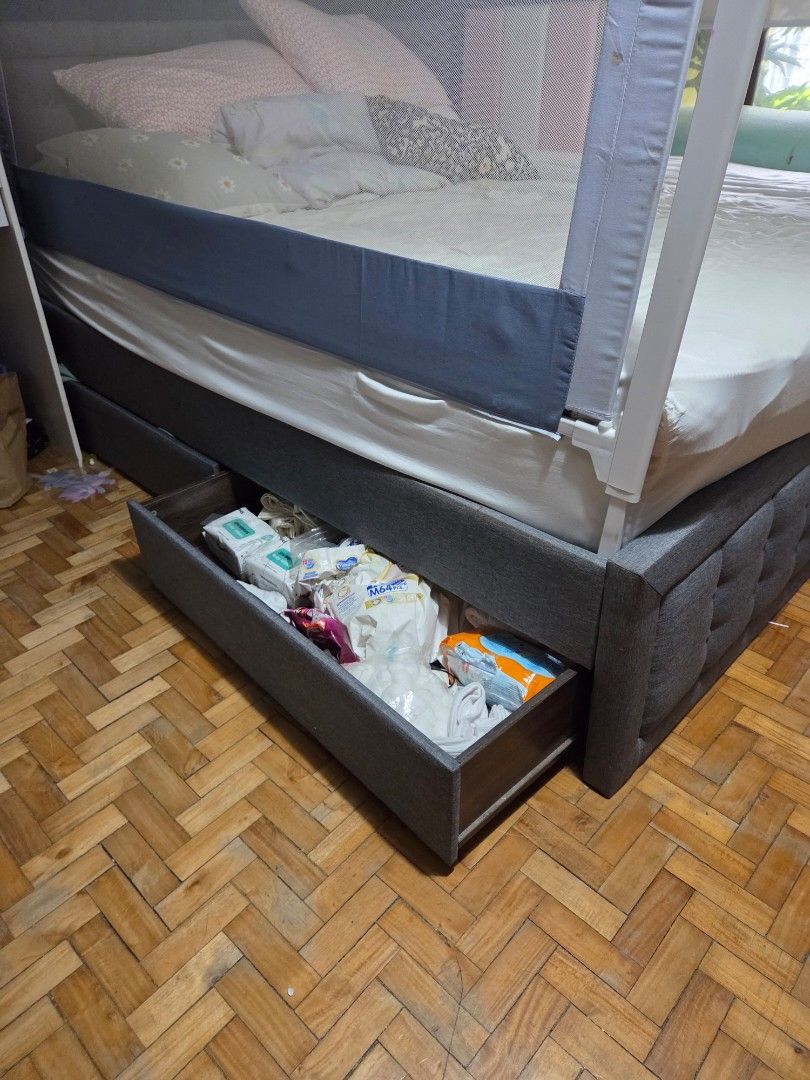 King Size Bed Frame with Pull-Out (Category: Bed Frames & Mattresses) located in Makati City. Submitted by alexi_l (Listing ID 1433438002, Image 3). Description: - King-size bed frame - Dark grey upholstered design - Tufted headboard - Pull-out drawers for storage - With pull out single bed - Wooden slat base - Mattress, bed rail, and bedding not included no lowballers please.