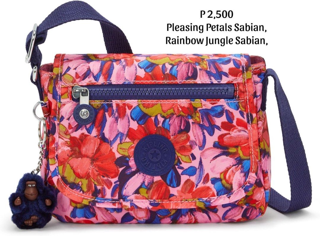 Kipling Sabian Pleasing Petals Crossbody Bag (Category: Cross-body Bags) located in Quezon City. Submitted by thebubbly (Listing ID 1433464350, Image 1). Description: - Kipling Sabian crossbody bag - Eye-catching floral print - Main compartment with zipper - Adjustable shoulder strap - Includes signature monkey keychain - Front zippered pocket - Secure flap closure - Vibrant color scheme: pink, red, blue, and purple.