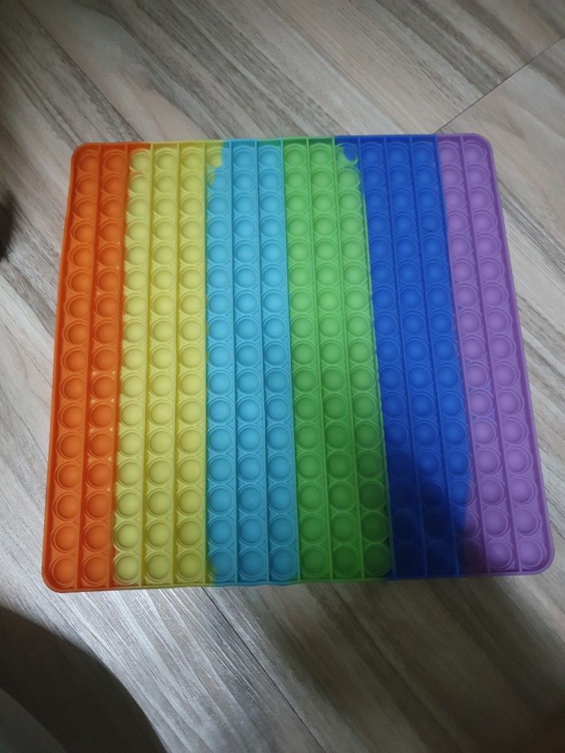 Large Rainbow Pop It Fidget Toy (Category: Kids Toys) located in Caloocan City. Submitted by lynette1977 (Listing ID 1433562573, Image 1). Description: - Large, square Pop It fidget toy - Features a vibrant rainbow color scheme - Made from durable silicone material - Designed for sensory play and stress reduction - In excellent, ready-to-use condition.