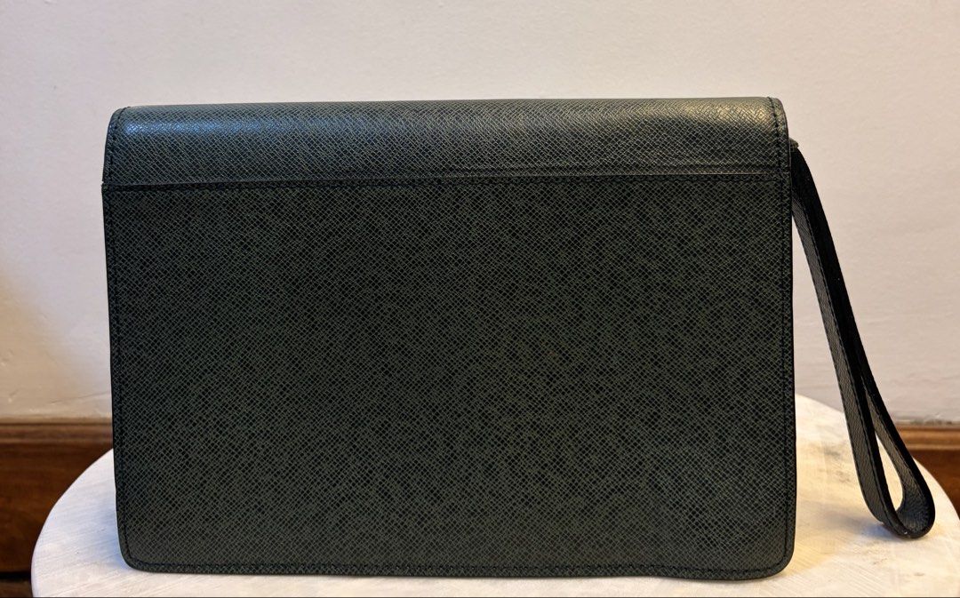 Louis Vuitton Green Clutch (Category: Luxury Bags & Wallets) located in Manila. Submitted by missmei07 (Listing ID 1433555748, Image 2). Description: - Authentic Louis Vuitton clutch - Stunning green color - Elegant gold-tone clasp and zipper - Convenient wrist strap - Signature Louis Vuitton logo inside - "Made in France" stamp - Perfect for any occasion.