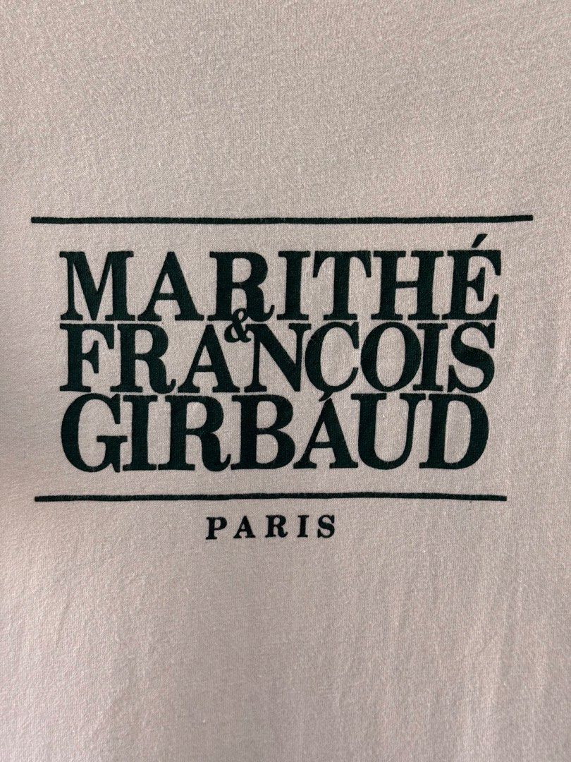 Marithe Francois Girbaud Paris T-shirt - Size M (Category: Shirts) located in Binan City. Submitted by ard__ (Listing ID 1433483554, Image 2). Description: Cream-colored Marithe Francois Girbaud Paris T-shirt. Features the brand's logo printed on the front. The size is M. The shirt has short sleeves and a crew neck. The tag is visible in the image. The back of the shirt is plain..