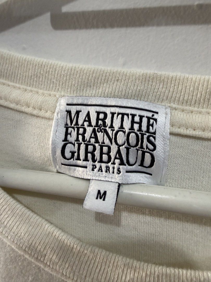 Marithe Francois Girbaud Paris T-shirt - Size M (Category: Shirts) located in Binan City. Submitted by ard__ (Listing ID 1433483554, Image 3). Description: Cream-colored Marithe Francois Girbaud Paris T-shirt. Features the brand's logo printed on the front. The size is M. The shirt has short sleeves and a crew neck. The tag is visible in the image. The back of the shirt is plain..