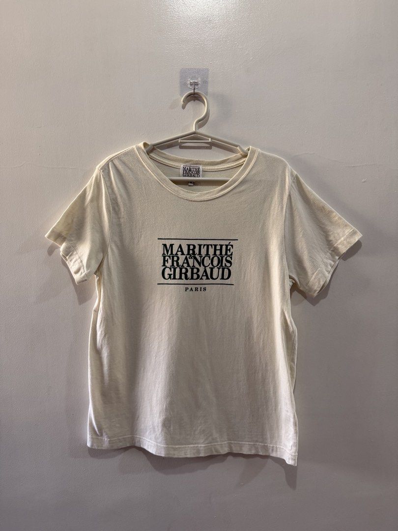 Marithe Francois Girbaud Paris T-shirt - Size M (Category: Shirts) located in Binan City. Submitted by ard__ (Listing ID 1433483554, Image 1). Description: Cream-colored Marithe Francois Girbaud Paris T-shirt. Features the brand's logo printed on the front. The size is M. The shirt has short sleeves and a crew neck. The tag is visible in the image. The back of the shirt is plain..