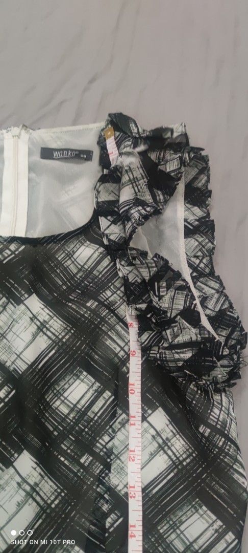 MNG Black and White Dress (Category: Dresses) located in Cavite. Submitted by Combiishop (Listing ID 1433454980, Image 1). Description: - Sleeveless dress - Black and white plaid pattern - Ruffled neckline - Fitted waist - Flared skirt - Zipper closure - Approximately 35 inches in length - Brand tag visible.