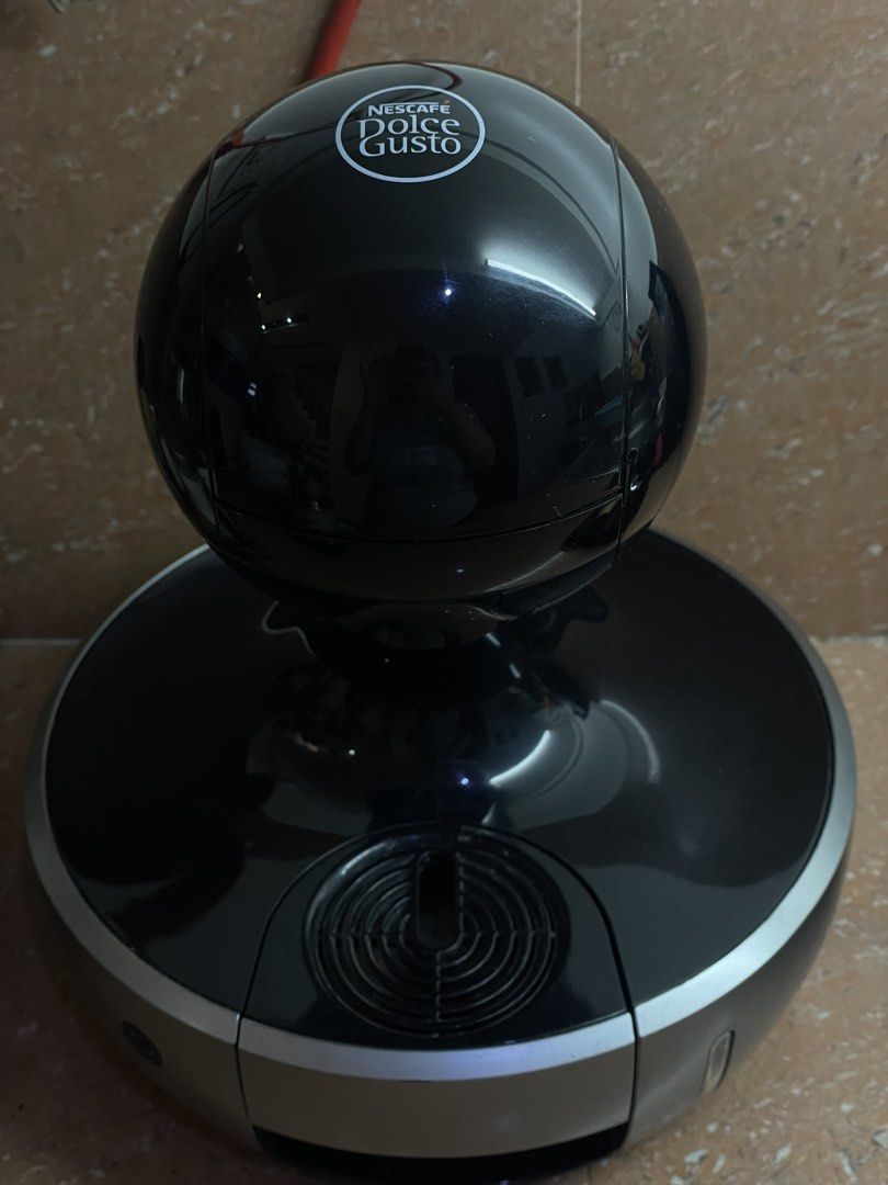 Nescafe Dolce Gusto Coffee Machine (Category: Coffee Machines & Makers) located in Quezon City. Submitted by sashiimii1720 (Listing ID 1433559847, Image 1). Description: - Nescafe Dolce Gusto coffee machine - Color: Black and Silver - Unique spherical design - Power button and water reservoir - Model: 9774 - Voltage: 220-240V - Frequency: 50/60Hz.