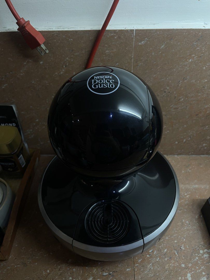 Nescafe Dolce Gusto Coffee Machine (Category: Coffee Machines & Makers) located in Quezon City. Submitted by sashiimii1720 (Listing ID 1433559847, Image 2). Description: - Nescafe Dolce Gusto coffee machine - Color: Black and Silver - Unique spherical design - Power button and water reservoir - Model: 9774 - Voltage: 220-240V - Frequency: 50/60Hz.