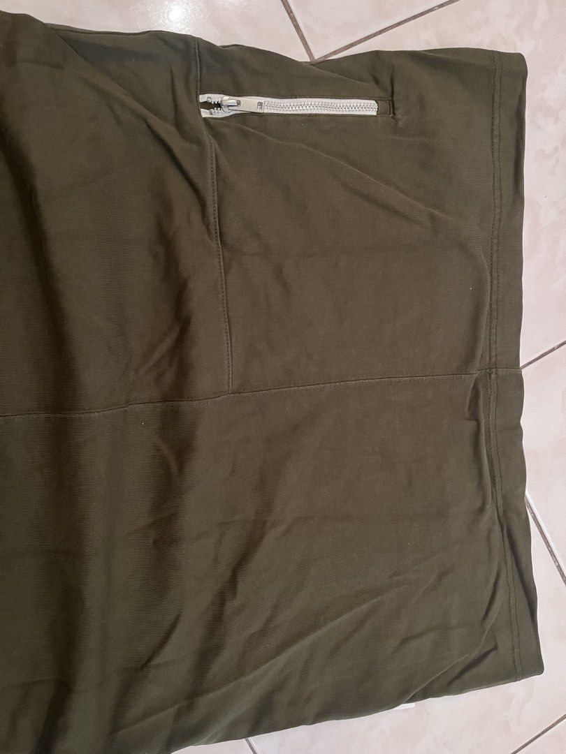 Nike Olive Green T-shirt (Category: Tshirts & Polo Shirts ) located in Quezon City. Submitted by markupapparel (Listing ID 1433452316, Image 2). Description: Original, makapal tela - Olive green Nike t-shirt - Size: L - Features a small Nike logo on the chest - White collar - Relaxed fit - Zippered pocket on the back.