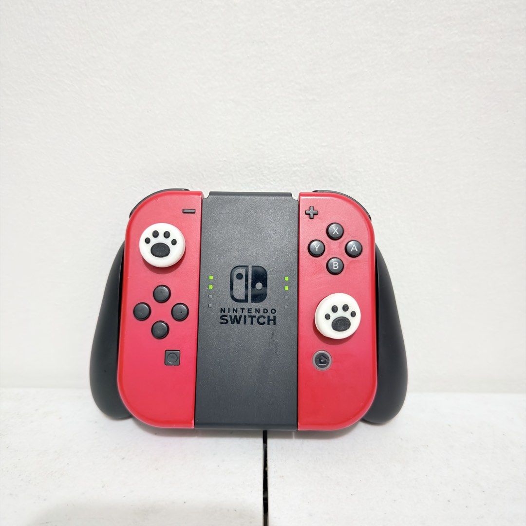 Nintendo switch oled v1 v2 original joycons RED (Category: Controllers) located in Valenzuela. Submitted by gearpandaph (Listing ID 1433460925, Image 3). Description: Original nintendo switch joycons No issue Sign of usage yes Wireless no issue With original grip Valenzuela.