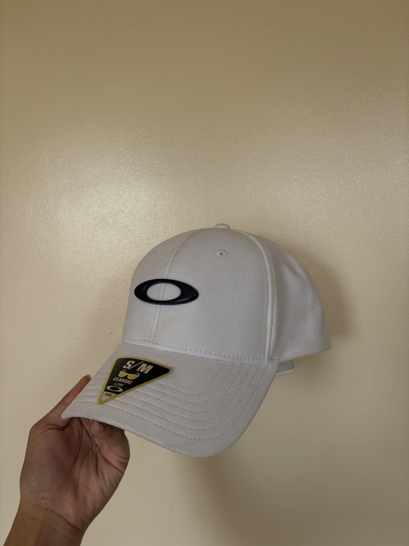 Oakley White Cap S/M (Category: Caps & Hats) located in Subic. Submitted by joyclutter (Listing ID 1433437439, Image 2). Description: - Oakley white cap - Size: S/M - Features Oakley logo on front - Oakley brand name on back - Made in Vietnam - Curved brim - Structured crown.