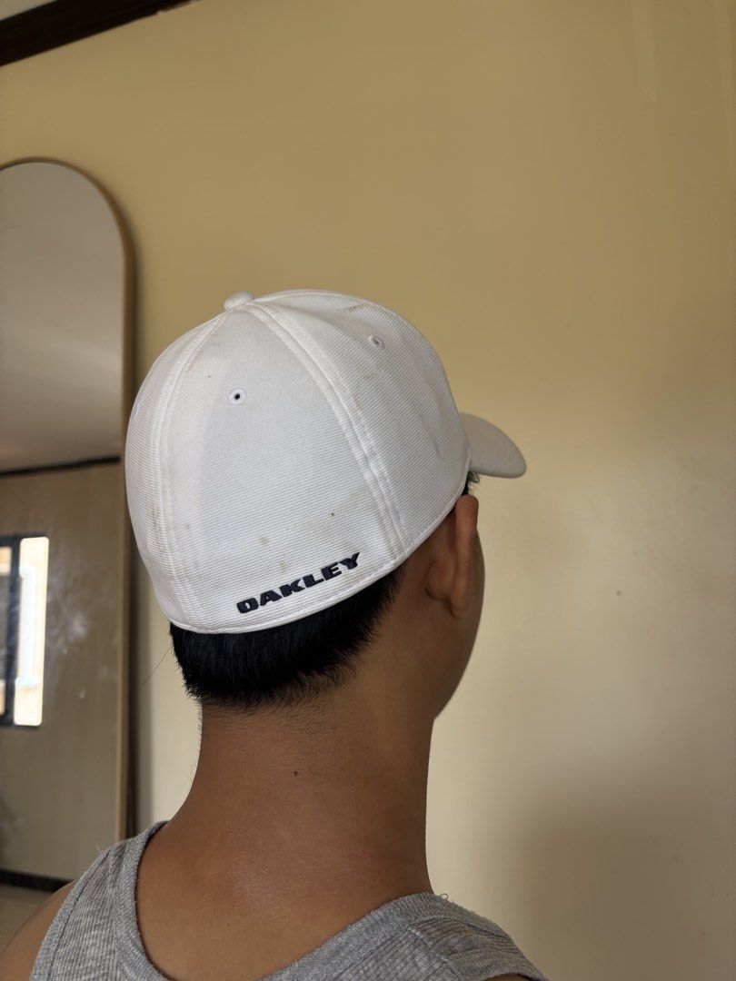 Oakley White Cap S/M (Category: Caps & Hats) located in Subic. Submitted by joyclutter (Listing ID 1433437439, Image 3). Description: - Oakley white cap - Size: S/M - Features Oakley logo on front - Oakley brand name on back - Made in Vietnam - Curved brim - Structured crown.