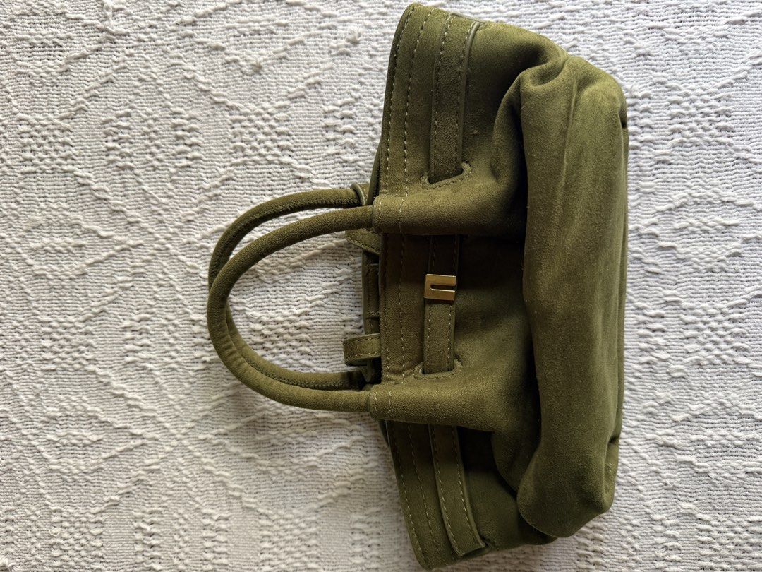 Olive Green Suede Handbag with Top Handle (Category: Tote Bags) located in Paranaque City. Submitted by izdeclutters (Listing ID 1433423001, Image 3). Description: - Olive green suede handbag - Top handle and detachable shoulder strap - Gold-tone clasp closure - Structured design - Light-colored interior lining - Includes a small interior pocket Purchased in Vietnam .