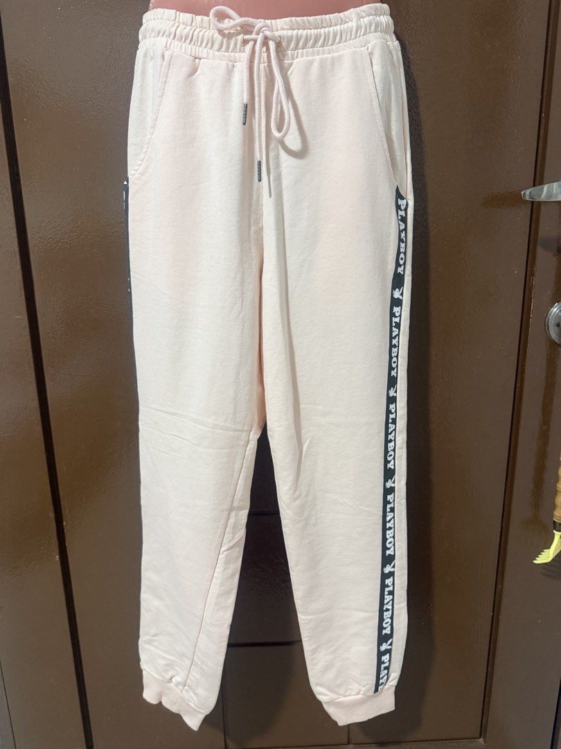 Playboy Ladies Jogger Pants Pink (Category: Other Bottoms) located in Makati City. Submitted by naysan (Listing ID 1433526403, Image 1). Description: - Playboy ladies jogger pants - Color: Light Peach - Size: S - Features: Drawstring waist, side pockets, Playboy logo - Material: Cotton blend - Condition: New with original tags attached - Care: Machine washable.
