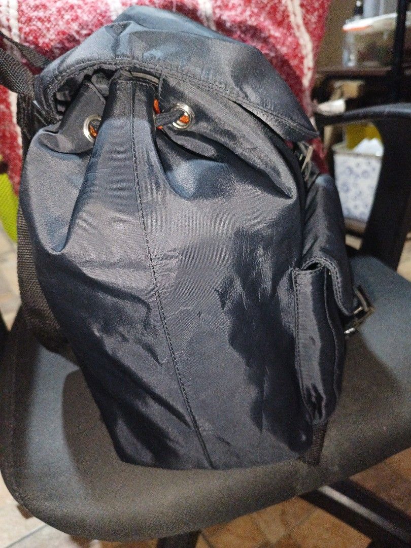 Prada Black Nylon Backpack (Category: Luxury Bags & Wallets) located in Rizal. Submitted by judithtillo19 (Listing ID 1433551940, Image 3). Description: - Prada backpack - Classic black nylon - Prada logo detail - Two front pockets with buckle closures - Adjustable straps for comfort - Top handle for easy carrying - Secure drawstring closure - Made from durable nylon Note: sign of usage, please refer last to pics....ipapasok and need lng lng higp