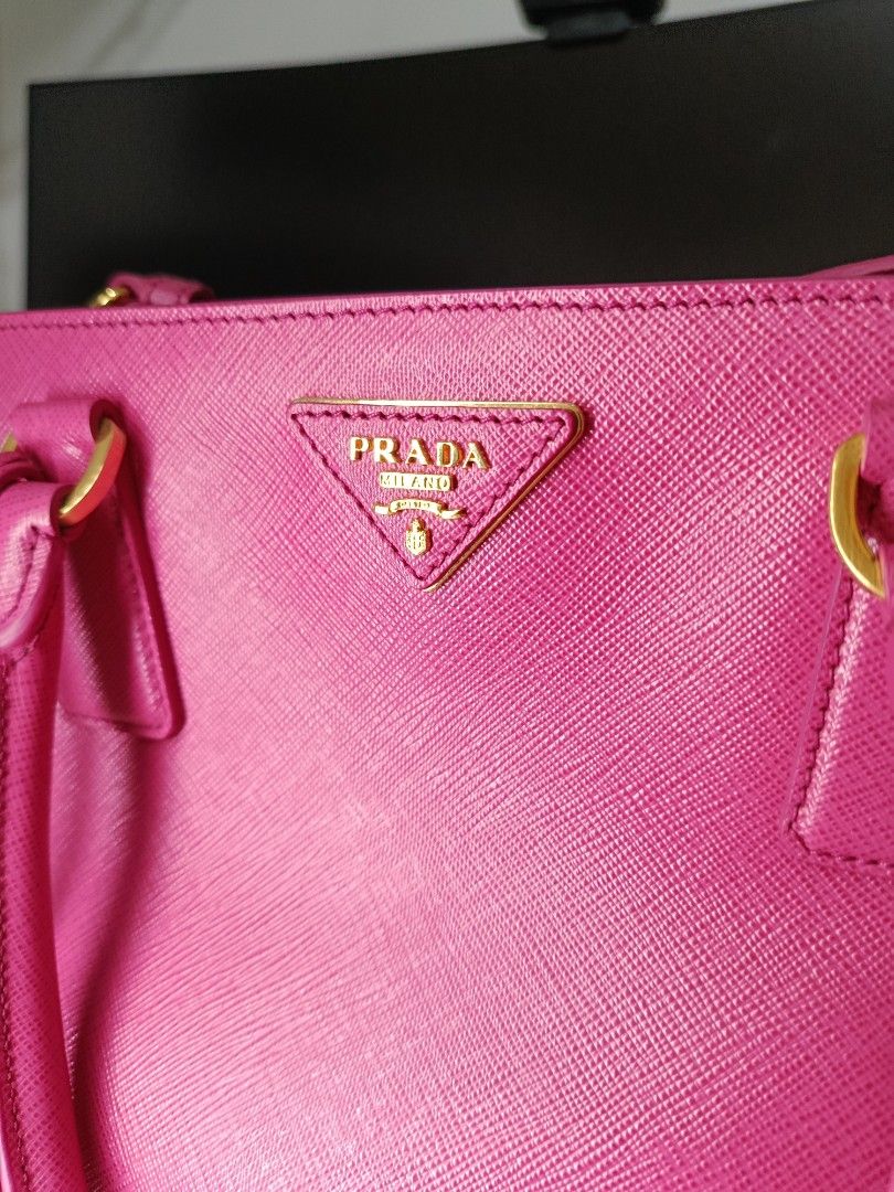 Prada Saffiano Lux (Category: Luxury Bags & Wallets) located in Manila. Submitted by zjdelacruz16 (Listing ID 1433469232, Image 1). Description: Prada Saffiano Lux Fuxia brandnew (never been used) complete with bag cover and documents asking price: 33k negotiate.