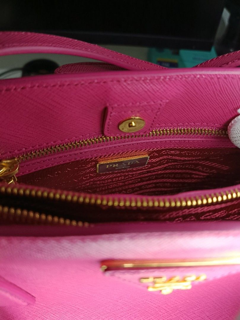 Prada Saffiano Lux (Category: Luxury Bags & Wallets) located in Manila. Submitted by zjdelacruz16 (Listing ID 1433469232, Image 2). Description: Prada Saffiano Lux Fuxia brandnew (never been used) complete with bag cover and documents asking price: 33k negotiate.