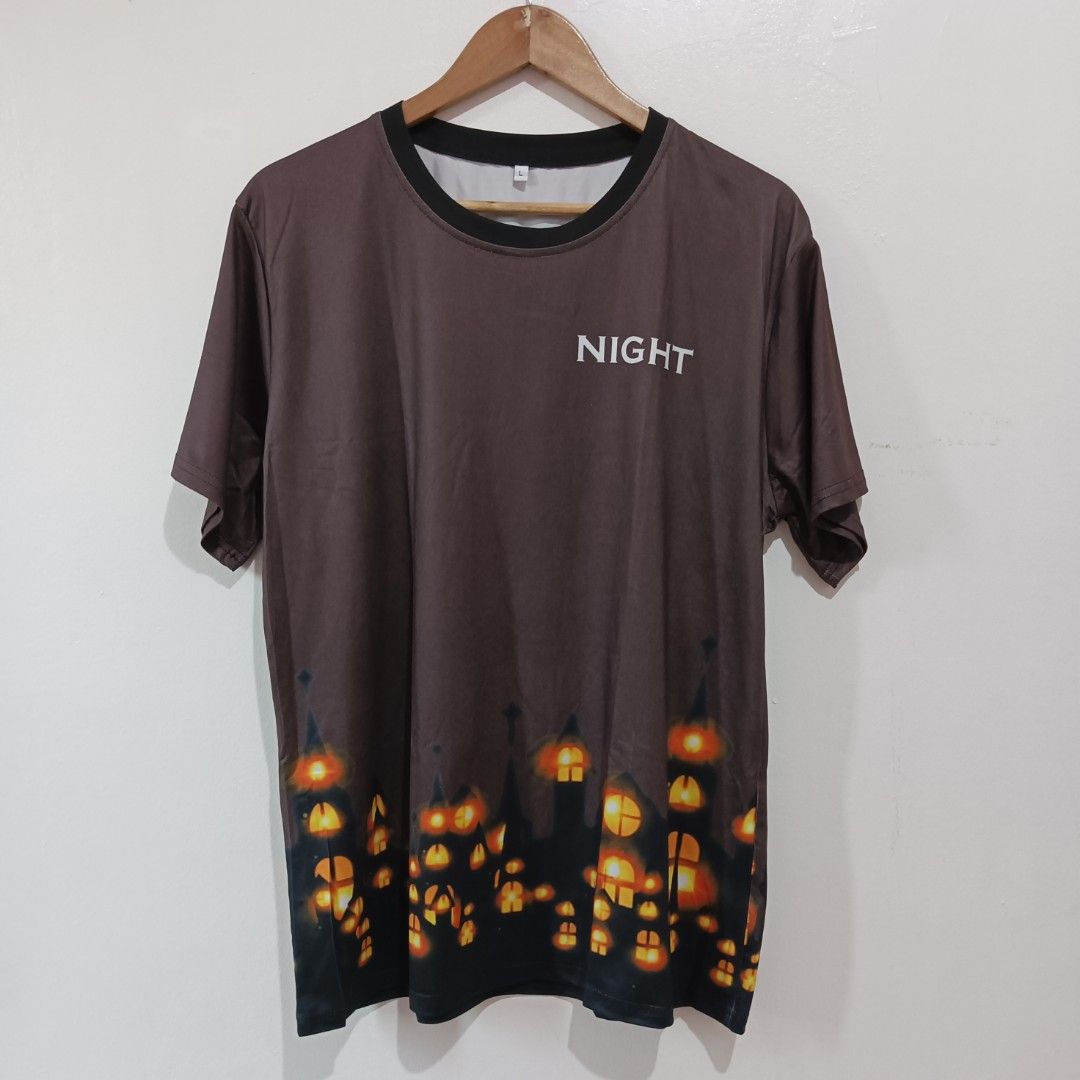 Shein short-sleeved t-shirt large (Category: Tshirts & Polo Shirts ) located in Subic. Submitted by mustardt_ (Listing ID 1433487772, Image 1). Description: item is a short-sleeved t-shirt featuring a 3D sublimation print of a nighttime cityscape with glowing windows and the word "NIGHT" on the chest size: w21.5in x l28in code: c454.