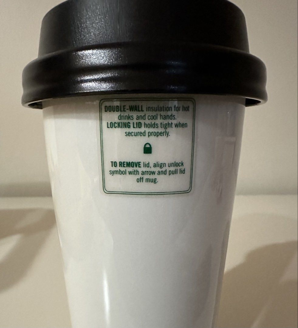 Starbucks Double-Wall Tumbler with Locking Lid (Category: Water Bottles & Tumblers) located in Manila. Submitted by caseller26 (Listing ID 1433505072, Image 2). Description: - Starbucks tumbler - Double-wall insulation - Locking lid - Starbucks logo - Keeps drinks at desired temperature - Black lid, white body.