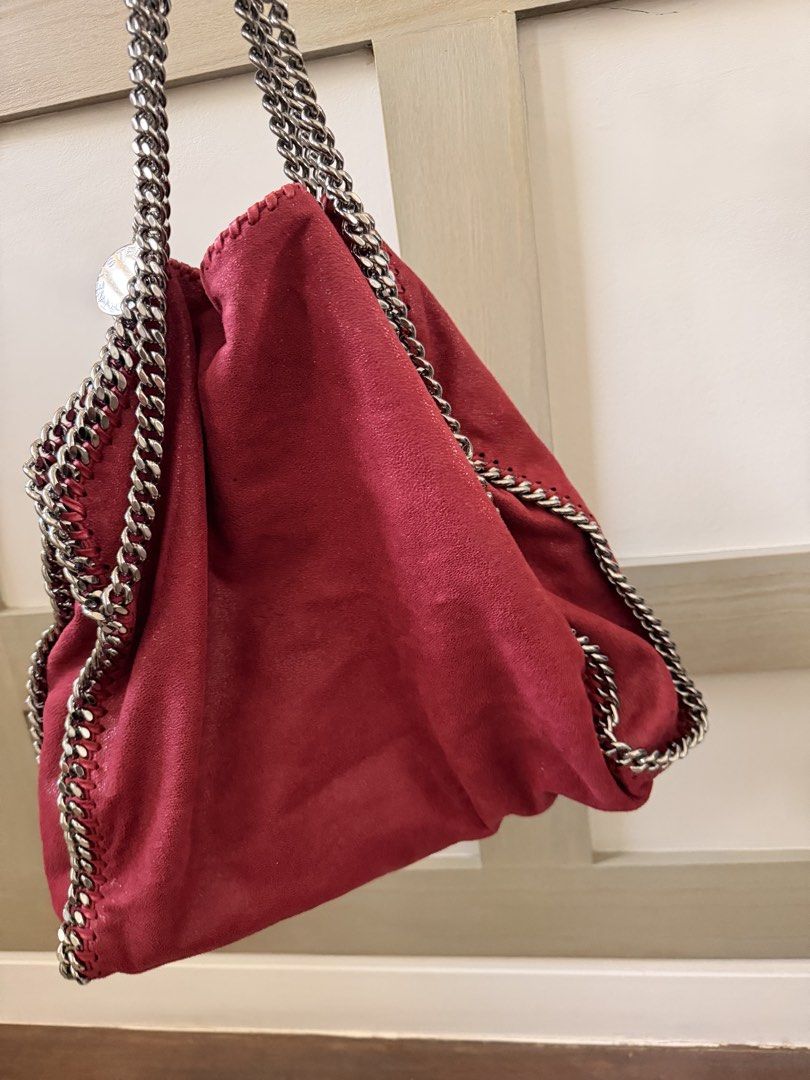 Stella McCartney Falabella Tote Bag (Category: Luxury Bags & Wallets) located in Santa Rosa. Submitted by privateclosetsale (Listing ID 1433435081, Image 3). Description: Stylish Stella McCartney Falabella tote bag in a vibrant red hue. Features a signature chain strap and trim. Includes a dust bag for storage. The bag is shown being worn, demonstrating its size and style..