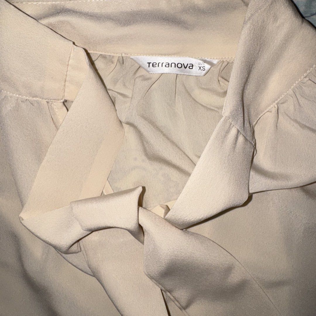 Terranova Beige Long Sleeve Blouse with Tie (Category: Blouses) located in Paranaque City. Submitted by lovedbyblanche (Listing ID 1433557778, Image 2). Description: - Terranova beige blouse - Size: XS - Features: - Tie detail - Collared neckline - Long sleeves with ruffled cuffs - Gathered waist.