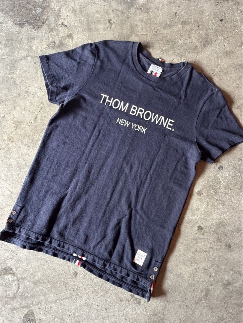 Thom Browne New York T-shirt (Category: Tshirts & Polo Shirts ) located in Calamba. Submitted by jannstuff (Listing ID 1433519347, Image 1). Description: - Navy blue Thom Browne T-shirt Size : 3 on tag fit M to L Excellent Condition Price:1500 + shipping fee.