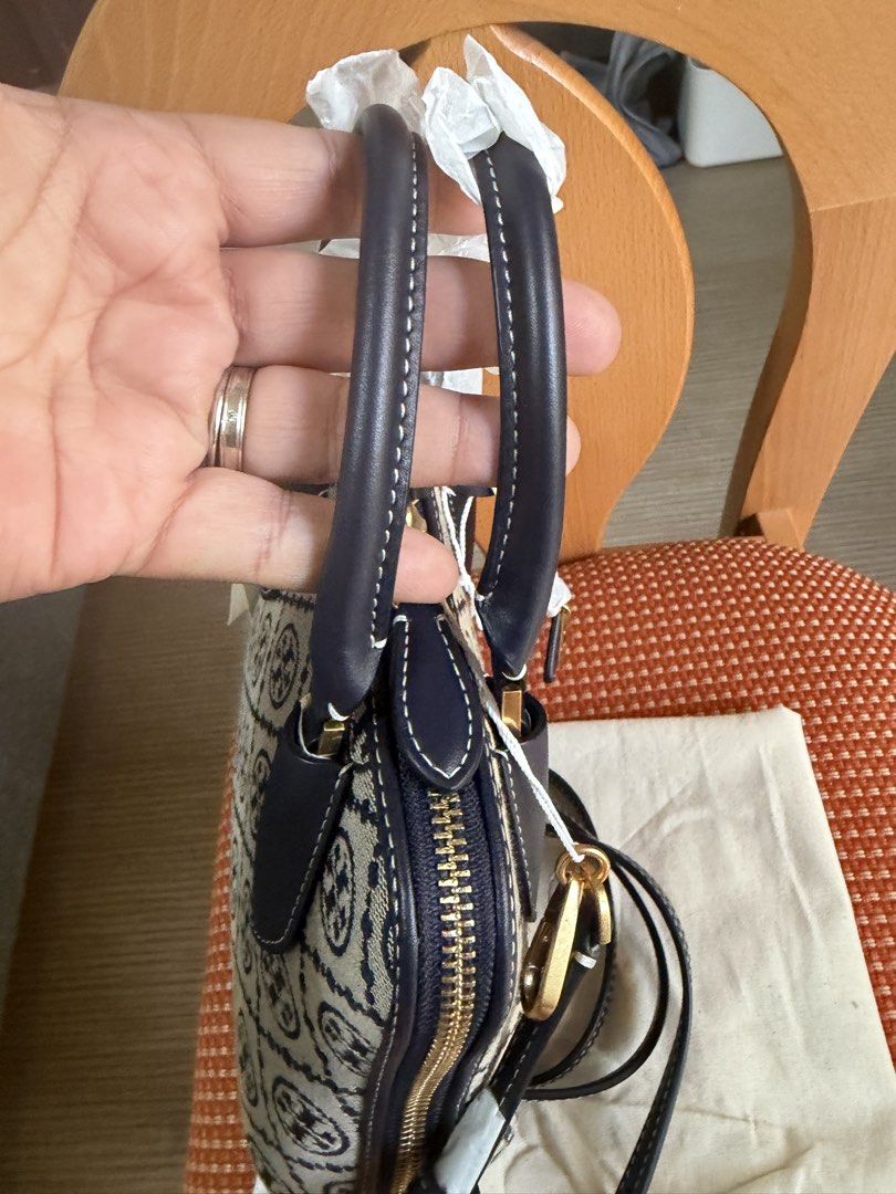 Tory Burch Mini T Monogram Jacquard Swing Bag - Navy (Category: Luxury Bags & Wallets) located in San Pedro. Submitted by misslumi (Listing ID 1433487371, Image 3). Description: Brand new from USA!! Tory Burch Mini T Monogram Jacquard Swing Bag - Navy Height: 6.5" (16.4cm); length: 8.3" (21cm); depth: 3" (7.8cm) Jacquard; calf leather trim Two way zipper closure Top handle with 3.4" (8.5cm) drop; adjustable, removable crossbody strap with 22.2" (