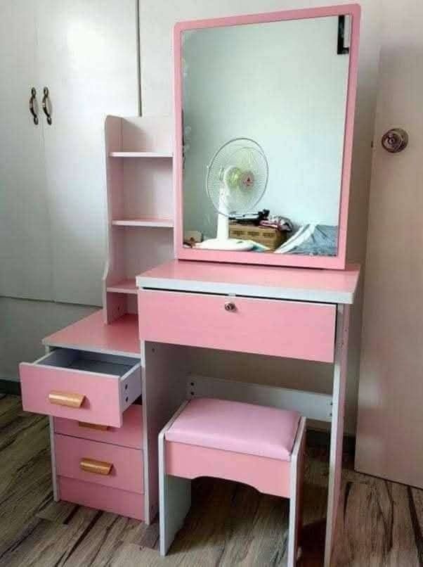 Vanity Table with Mirror and Stool (Category: Tables & Sets) located in Caloocan City. Submitted by swiftflower_802790 (Listing ID 1433426105, Image 3). Description: - Vanity table set includes table, mirror, stool, and side cabinet. - Features multiple shelves for storage. - Includes a drawer with a lock for security. - Stool has a comfortable, cushioned seat. - Available colors: Brown, White, Pink. - Perfect for bedroom or dressing area..