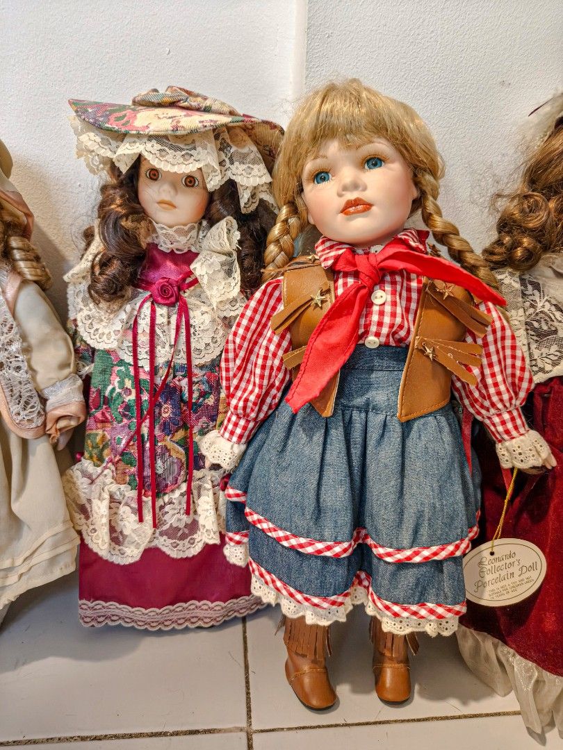 Vintage Porcelain Dolls (Category: Figurines & Statues) located in Imus. Submitted by anbee73 (Listing ID 1433581668, Image 1). Description: - Vintage porcelain dolls - Dolls dressed in unique outfits: - Checkered shirt, denim skirt, and brown boots - Floral dress and hat - Detailed facial features - Perfect for collectors! -Bundle.