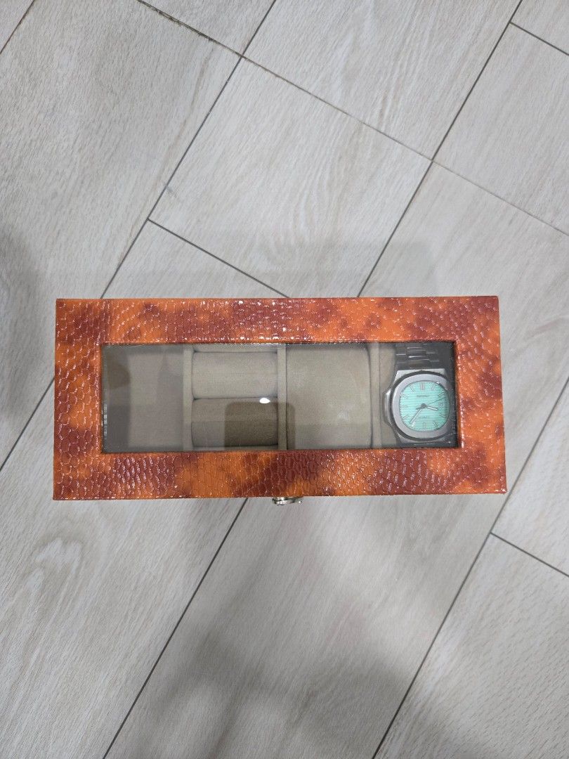 Watch Display Box - Orange (Category: Women's Watches) located in Manila. Submitted by aynatpc (Listing ID 1433522495, Image 1). Description: - Orange, textured exterior - Clear viewing window - Multiple compartments for watches - Soft interior lining - Secure metal clasp Seiko not included.