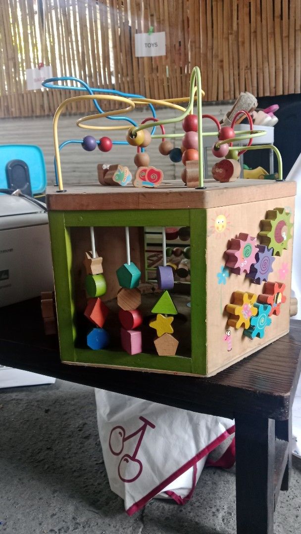 Wooden Activity Cube (Category: Infant Playtime) located in Taguig. Submitted by gstpc (Listing ID 1433458137, Image 2). Description: - Wooden activity cube for toddlers and young children. - Includes bead mazes, shape sorters, and gears. - Designed with bright colors and various shapes. - Helps develop fine motor skills. - Improves hand-eye coordination..