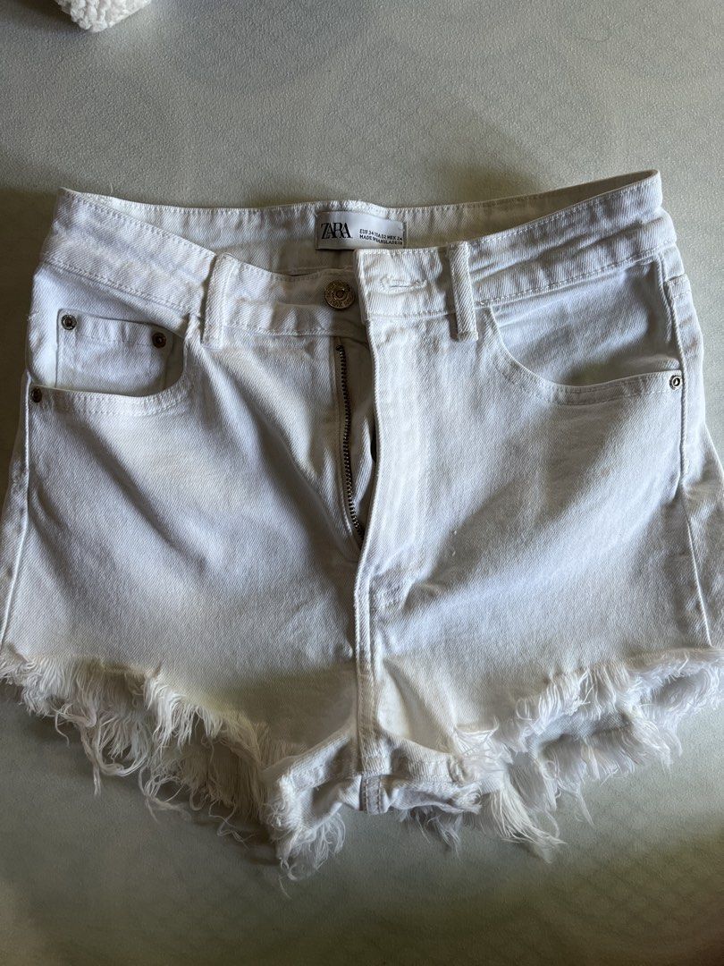Zara High Waist White Denim Shorts (Category: Shorts) located in Quezon City. Submitted by byyyee (Listing ID 1433483003, Image 1). Description: - Decluttering -Fave white shorts but have too many already hence why i'm selling - Classic five-pocket design - Zip fly and button closure - Frayed hem.