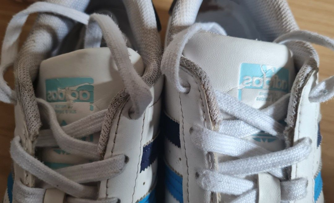 Adidas Superstar White Blue Sneakers (Category: Babies & Kids Fashion) located in Pasig City. Submitted by rakel10 (Listing ID 1433647346, Image 3). Description: - Adidas Superstar sneakers - White with blue stripes - Size: US 5, UK 4 1/2, FR 37 1/3, JP 235, CHN 230 - Features Adidas logo - Please manage your expectations, as this is a pre-loved item and has noticeable flaws, as shown in the photos. - Stored in the cabinet for some time, so some 