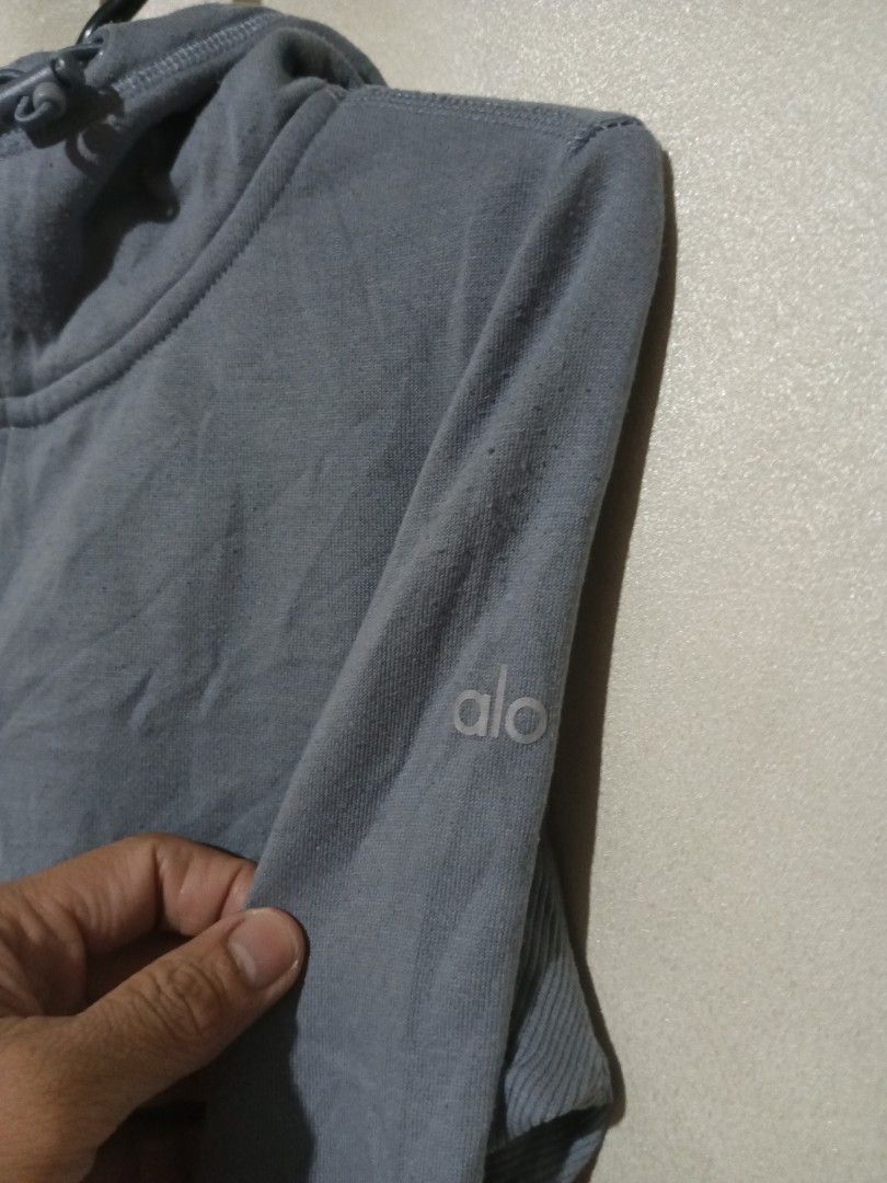 Alo Yoga Full Zip Hoodie (Category: Coats, Jackets and Outerwear) located in Quezon City. Submitted by ryanyusores (Listing ID 1433617458, Image 3). Description: - Alo Yoga hoodie - Full zip closure - Hooded - Thumbholes - Brand logo detail - Fitted design - Ribbed cuffs - Soft material.