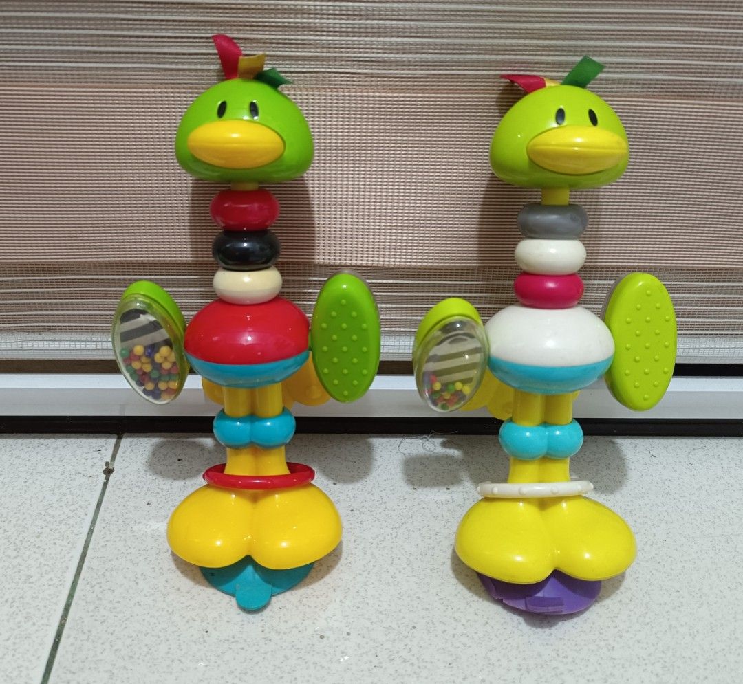 Baby Rattle Toy for Stroller (Category: Infant Playtime) located in Pasig City. Submitted by joaquin_1207 (Listing ID 1433627199, Image 1). Description: - 120 pesos each - Adorable bird-shaped rattle toy. - Designed for babies and toddlers. - Features a green head, yellow beak, and colorful rings. - Wings with beads for added sensory play. - Base is yellow and blue. - Made of durable plastic. - Produces a delightful rattle sound..