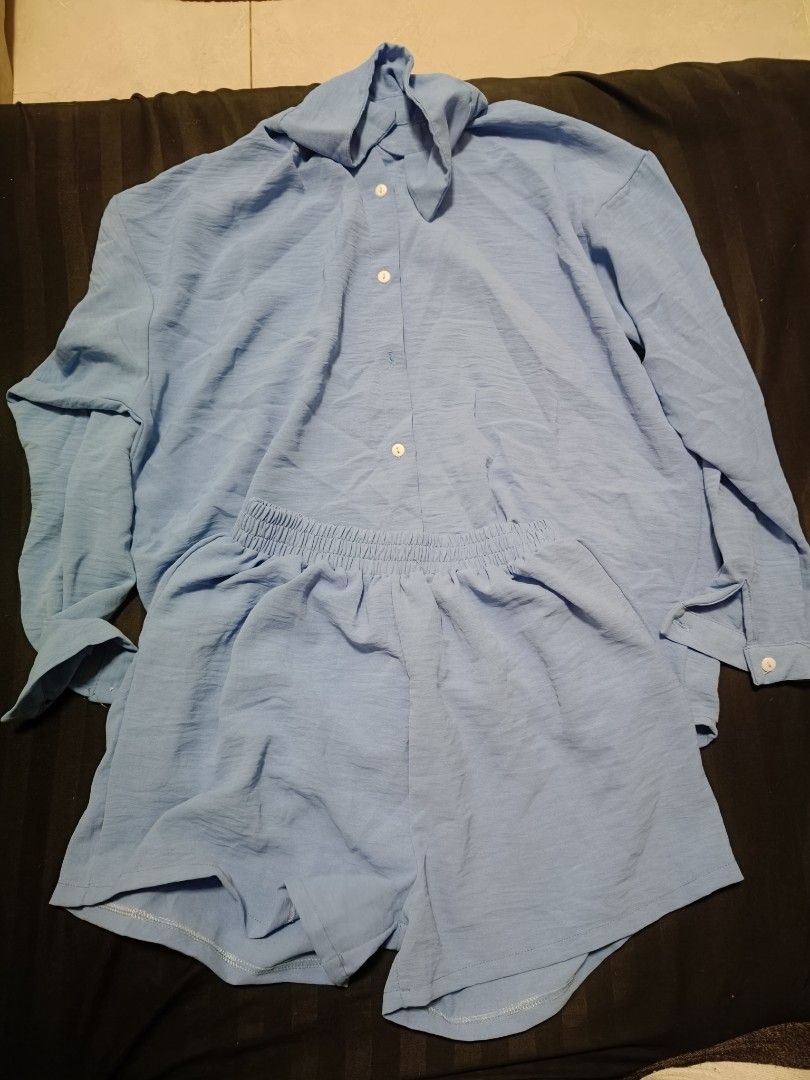 Blue Coordinates Set (Category: Sets or Coordinates) located in Manila. Submitted by cristysuarez (Listing ID 1433599894, Image 3). Description: - Includes a long-sleeved button-down shirt - Matching shorts with elastic waistband - Shirt features a collar and button closures.