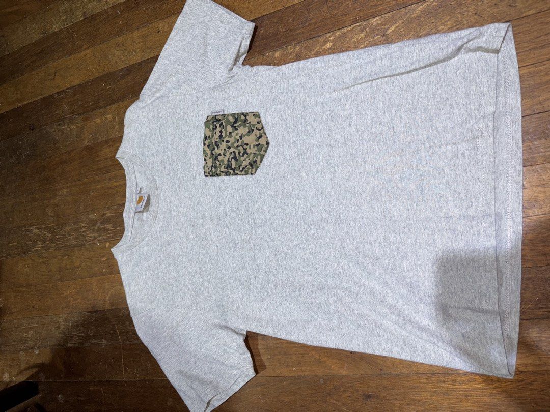 Carhartt Camo Pocket Tee (Category: Tshirts & Polo Shirts ) located in Quezon City. Submitted by bigbert99 (Listing ID 1433727871, Image 2). Description: - Gray Carhartt t-shirt - Camouflage pocket - Crew neck - Short sleeves - Carhartt logo on pocket and neckline - Comfortable, soft material.