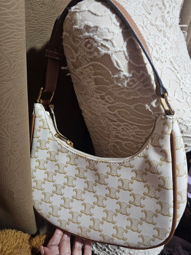 Celine Triomphe Shoulder Bag (Category: Luxury Bags & Wallets) located in Angeles City. Submitted by kodachi10 (Listing ID 1433752995, Image 2). Description: - Celine Triomphe shoulder bag - Signature pattern - Brown leather strap and trim - Fabric lining - Zipper closure - Celine Paris logo - Curved shape - No leather tags inside.