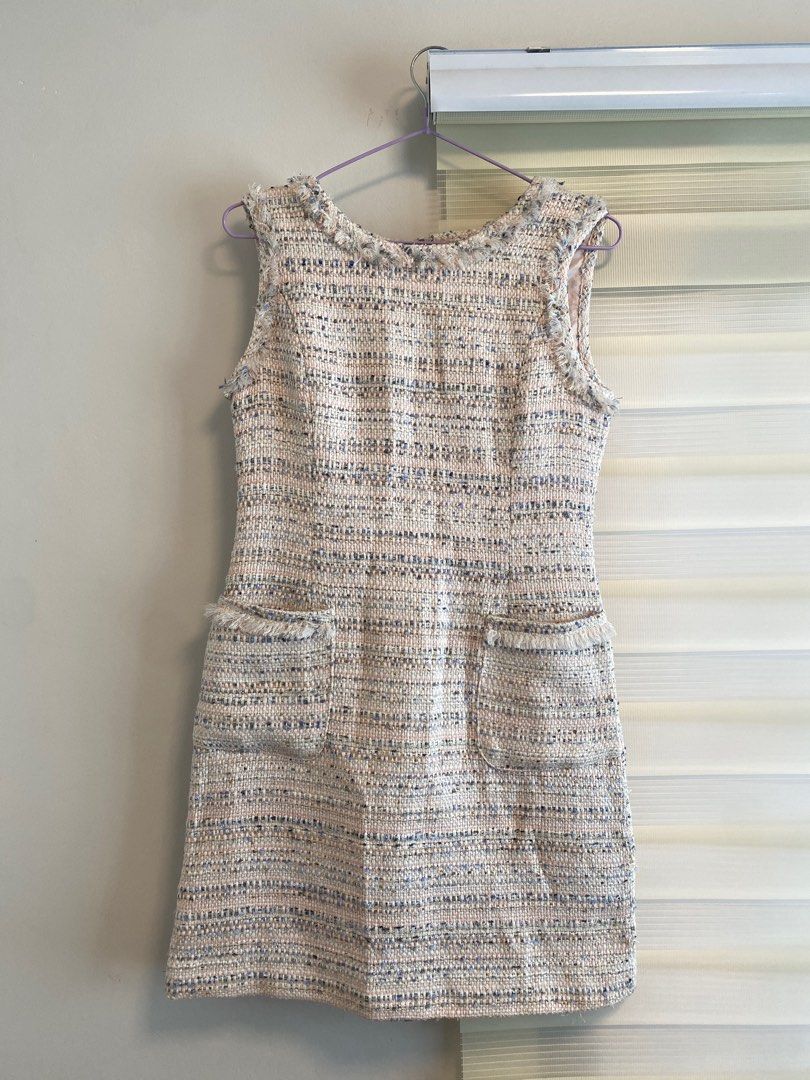Chanel Tweed Dress (Category: Dresses) located in San Jose del Monte. Submitted by shoplikecess (Listing ID 1433610116, Image 1). Description: Elegant tweed dress featuring a sleeveless design and two front pockets. The dress has a frayed neckline and hem, adding a touch of texture. It includes a zipper closure at the back. The dress is a neutral color with hints of blue and pink. The dress is approximately 33 inches long..