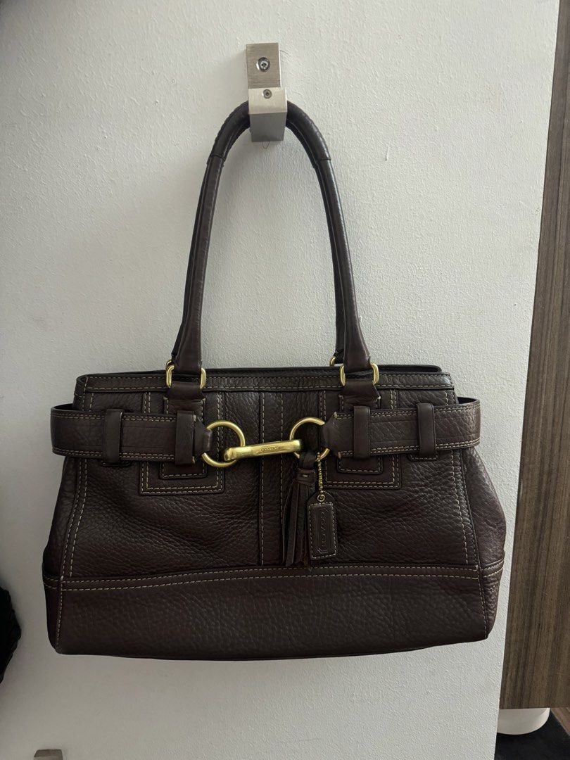 Coach Hamptons Pebbled Leather Hobo Bag (Category: Luxury Bags & Wallets) located in Manila. Submitted by mae-v (Listing ID 1433595492, Image 1). Description: - Authentic Coach handbag; Sourced in Japan - Crafted from brown pebbled leather - Top handle design - Features contrast stitching, belted side accents, and equestrian style hardware - Interior with multiple compartments - Secure buckle closure.