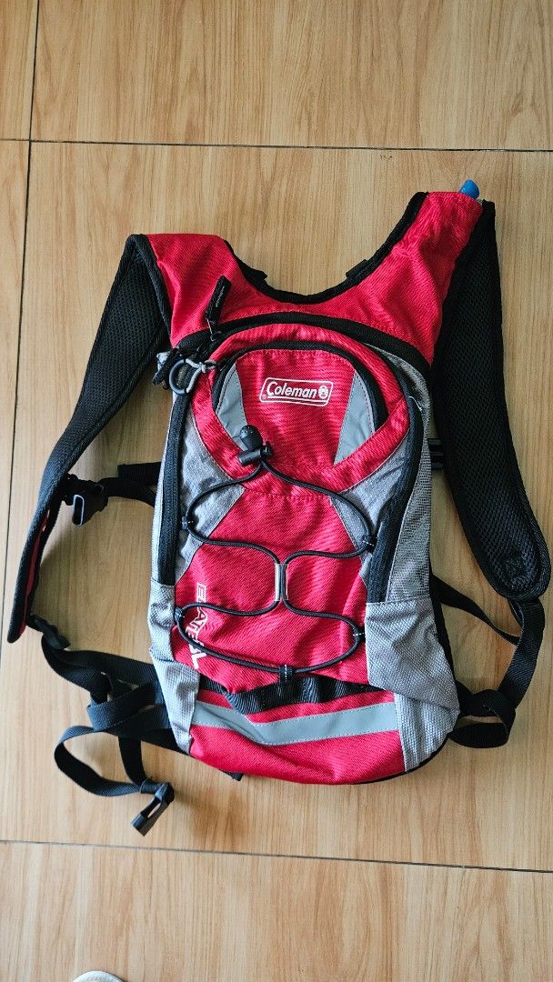 Coleman Hydration Backpack (Category: Backpacks) located in Alfonso. Submitted by jbcamet (Listing ID 1433667265, Image 1). Description: - Coleman hydration backpack - Red and gray design - Adjustable straps for a comfortable fit - Multiple compartments, including hydration reservoir space - Reflective strips for visibility.