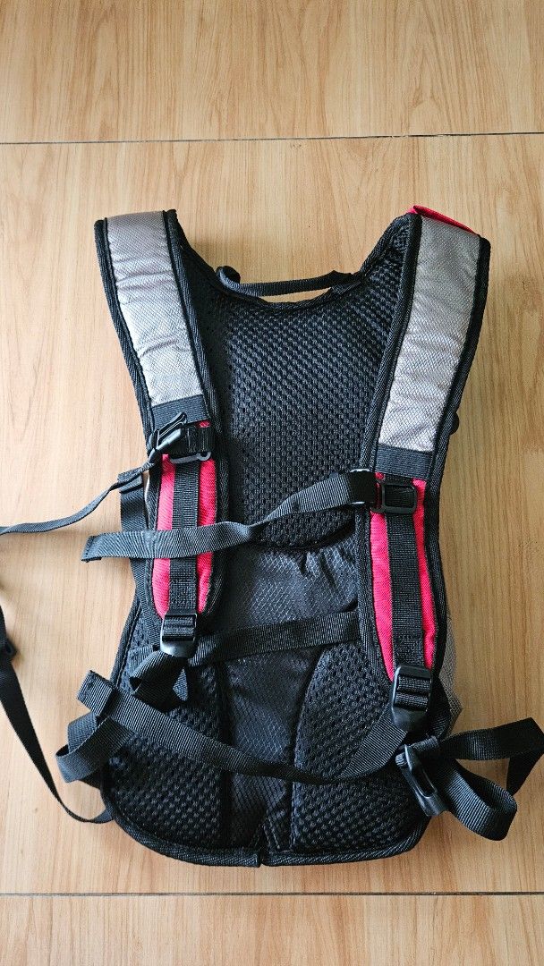 Coleman Hydration Backpack (Category: Backpacks) located in Alfonso. Submitted by jbcamet (Listing ID 1433667265, Image 3). Description: - Coleman hydration backpack - Red and gray design - Adjustable straps for a comfortable fit - Multiple compartments, including hydration reservoir space - Reflective strips for visibility.