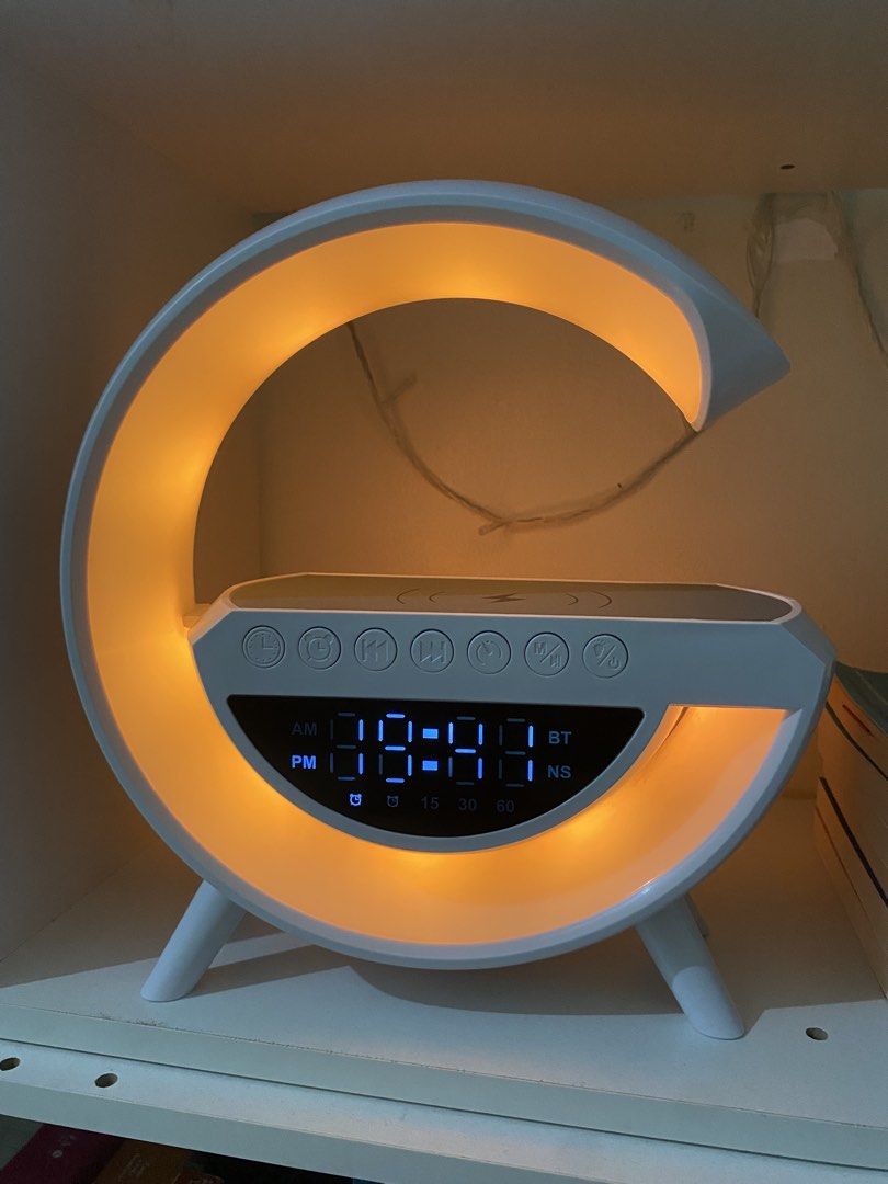 Digital Bluetooth Clock (Category: Clocks) located in Makati City. Submitted by makatigirlpreloved (Listing ID 1433692024, Image 2). Description: - Sunrise alarm clock with wireless charging - Digital display for time - Multiple light settings - Bluetooth connectivity - USB port and AUX input - Unique curved light design.
