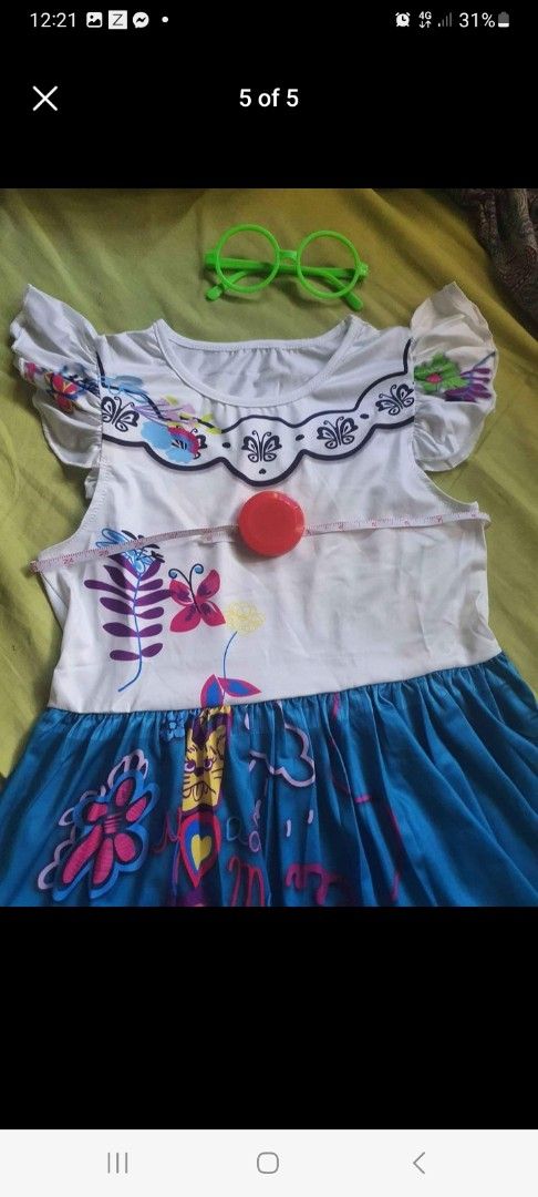Encanto Dress with Accessories (Mirabel) (Category: Babies & Kids Fashion) located in Pasig City. Submitted by peppermintpatty_1221 (Listing ID 1433778241, Image 3). Description: - Encanto-themed dress - White top with floral accents - Blue skirt with vibrant floral patterns - Includes matching handbag - Comes with green glasses - Perfect for dress-up or themed parties.