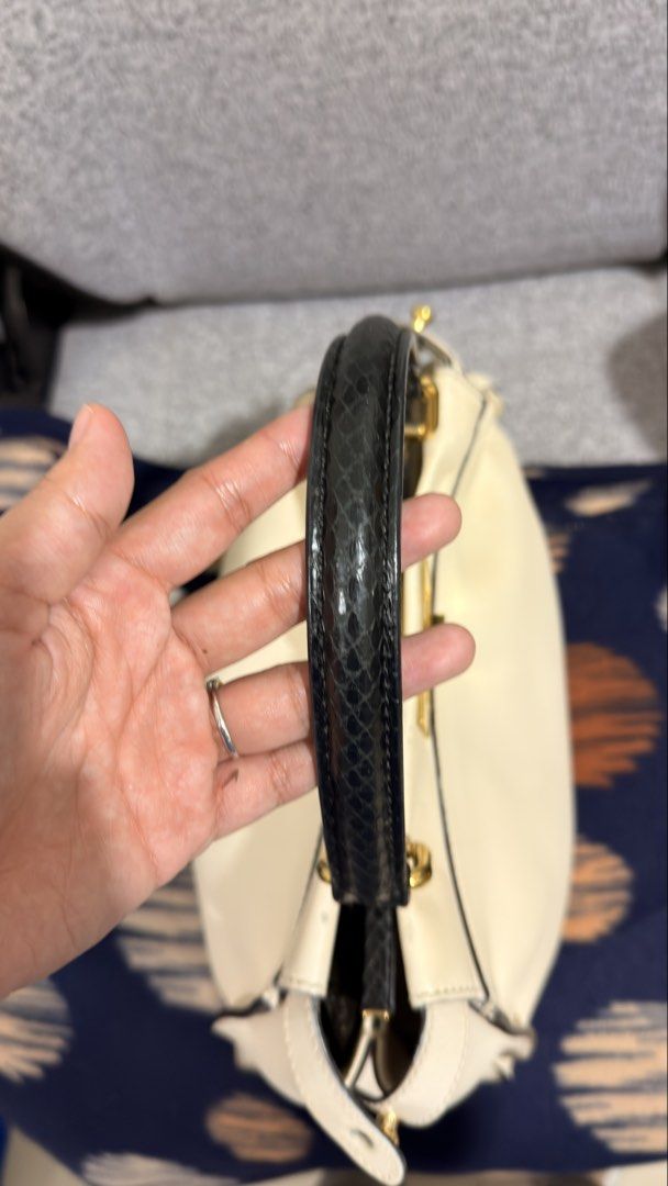Fendi Peekaboo Black Python handle (medium size) (Category: Luxury Bags & Wallets) located in Mandaluyong City. Submitted by cdvcdv (Listing ID 1433758915, Image 2). Description: Fendi Peekaboo in ivory leather with python handle (Project Bag) This bag is being sold as a "Project Bag" and is priced accordingly. Due to improper storage, it has the following significant flaws: Leather Condition: Certain areas of the smooth ivory leather have harden