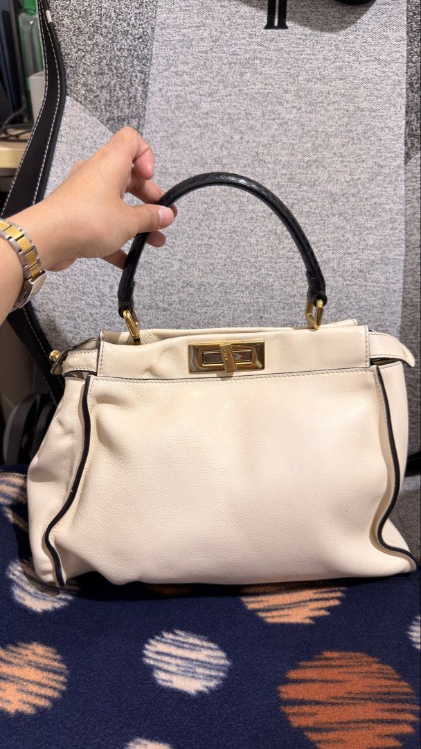 Fendi Peekaboo Black Python handle (medium size) (Category: Luxury Bags & Wallets) located in Mandaluyong City. Submitted by cdvcdv (Listing ID 1433758915, Image 1). Description: Fendi Peekaboo in ivory leather with python handle (Project Bag) This bag is being sold as a "Project Bag" and is priced accordingly. Due to improper storage, it has the following significant flaws: Leather Condition: Certain areas of the smooth ivory leather have harden