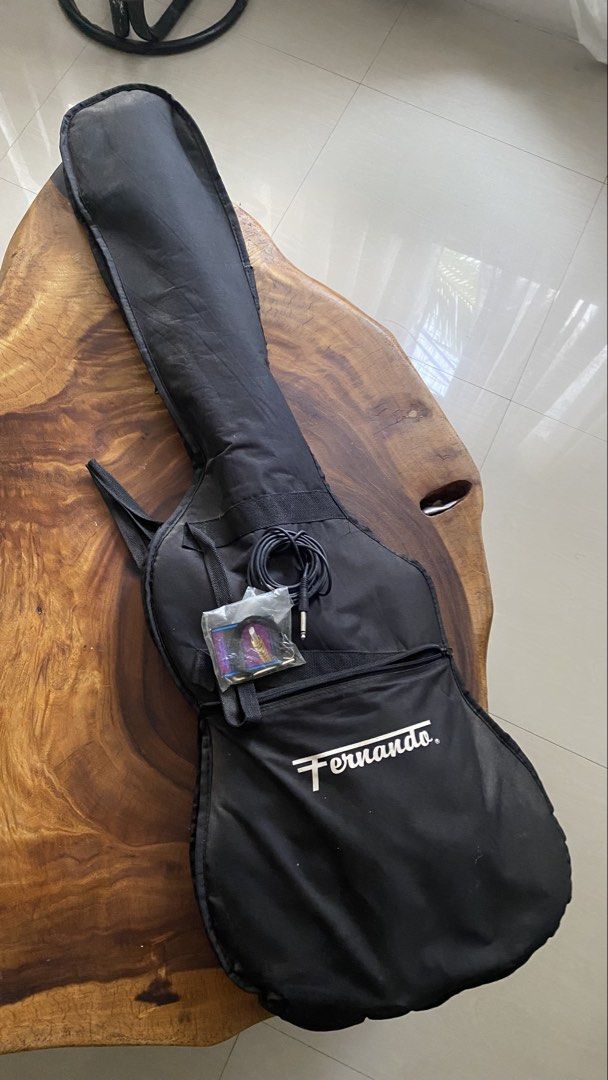 Fernando Unique Series Bass Guitar (Category: Musical Instruments) located in Manila. Submitted by cityboi010403 (Listing ID 1433600967, Image 2). Description: - Black Fernando Unique Series bass guitar - White pickguard - Includes: gig bag, strap, and cable - 4 strings - Features tuning pegs - Fernando logo on headstock and neck plate - No Amplifier included - Minor scratches - Faulty tuners - IN VERY GOOD CONDITION RFS: Declutter PRICE NEGOTIAB