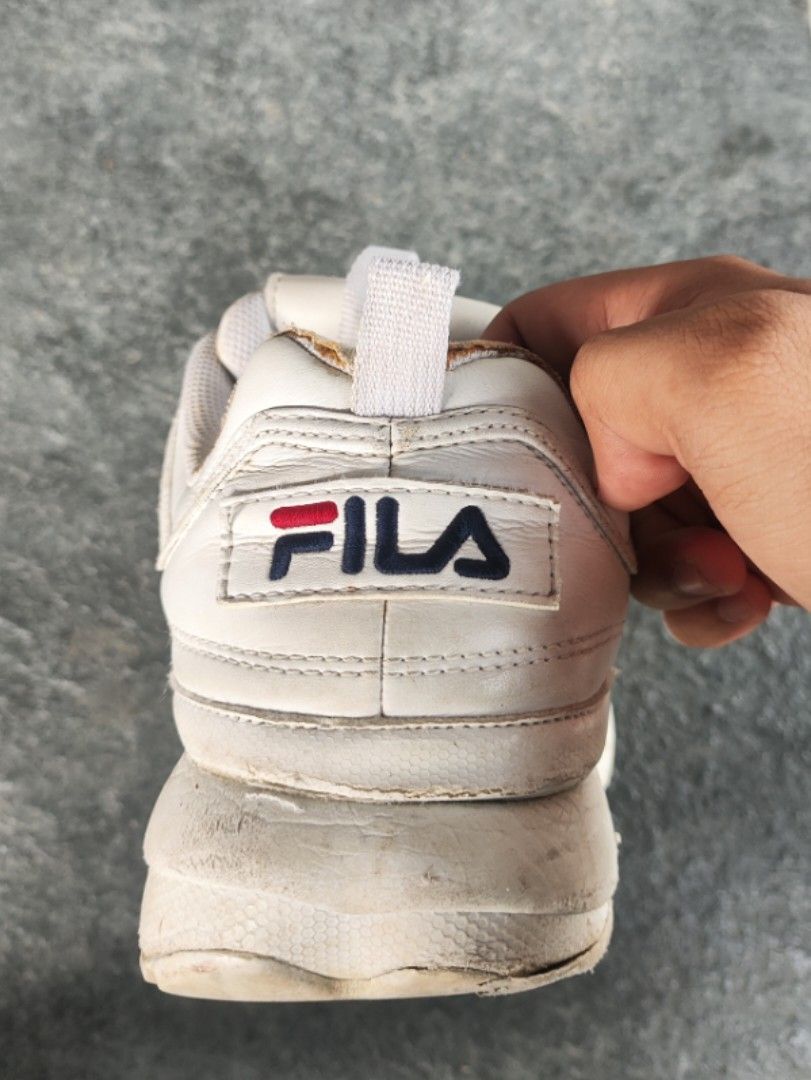 Fila Disruptor II White Sneakers (Category: Sneakers) located in Tagudin. Submitted by 77sleep (Listing ID 1433661299, Image 3). Description: - Fila Disruptor II sneakers - White color - Fila logo on tongue and side - Chunky sole - White laces - Pre-owned condition - Visible wear and tear on soles and uppers.