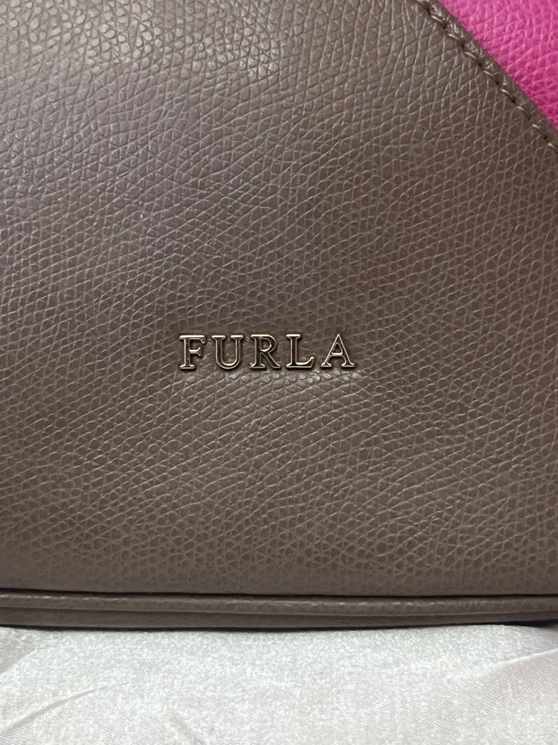 Furla Colorblock Satchel Bag (Category: Luxury Bags & Wallets) located in Victorias. Submitted by lan1877 (Listing ID 1433696705, Image 3). Description: - Authentic Furla Satchel Bag - Colorblock design: Gray, Pink, Brown - Features: - Top handle - Detachable shoulder strap - Metal clasp closure W dust bag No issue - Includes dust bag - Interior: Furla label with "Genuine Leather" print - Made in Romania 3k plus sf.