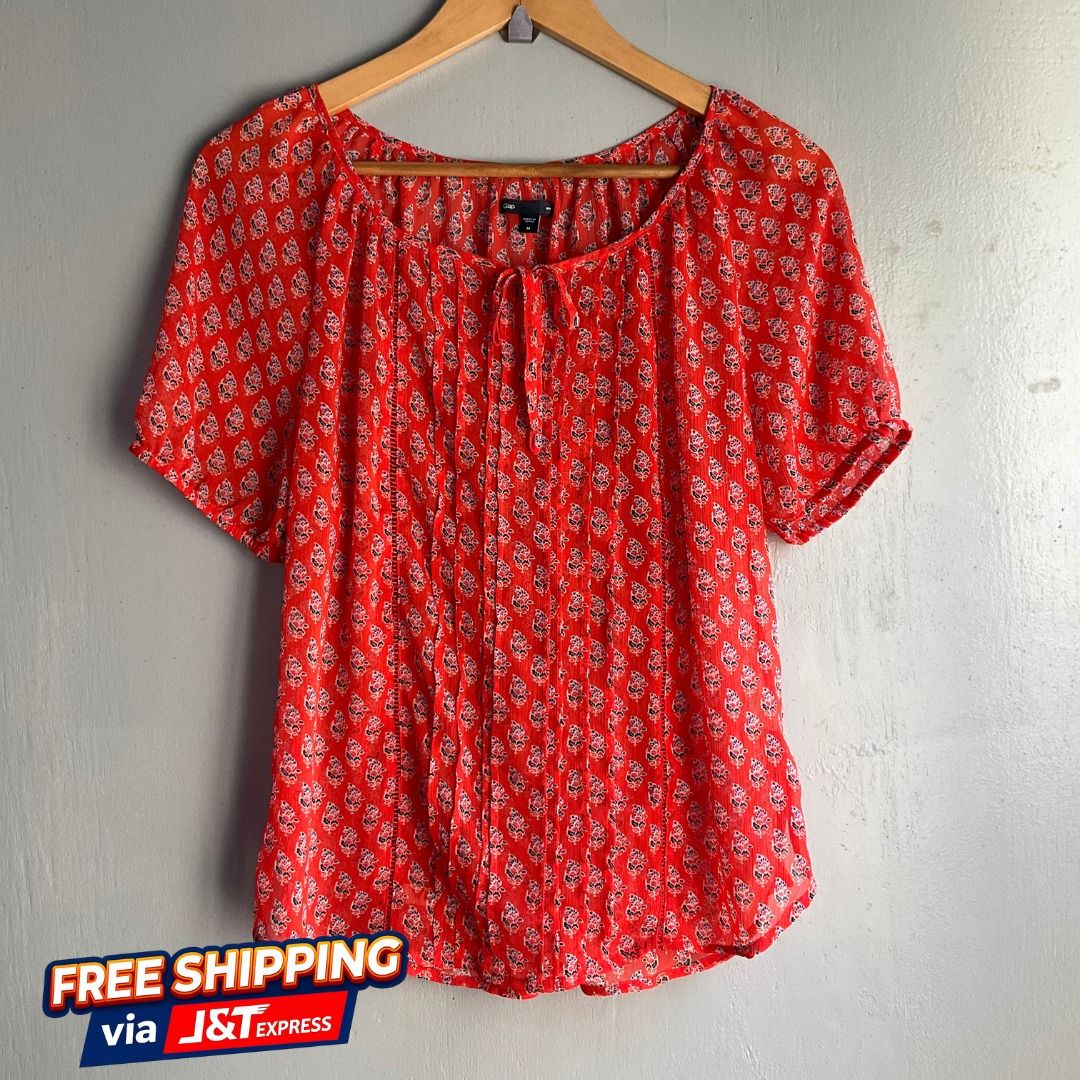 GAP | Floral Print Pleated Peasant Blouse (Category: Blouses) located in Cagayan de Oro. Submitted by random_thrift.av (Listing ID 1433639106, Image 1). Description: ◇Dim: W19 L24 ◇ Vibrant coral-red top featuring a delicate all-over floral motif ◇ Flattering pleated front detailing, a dainty tie-neckline, and comfortable elasticized puff sleeves ◇ Due to brightness, lighting or other factors, the color of the actual product can be slightly diffe